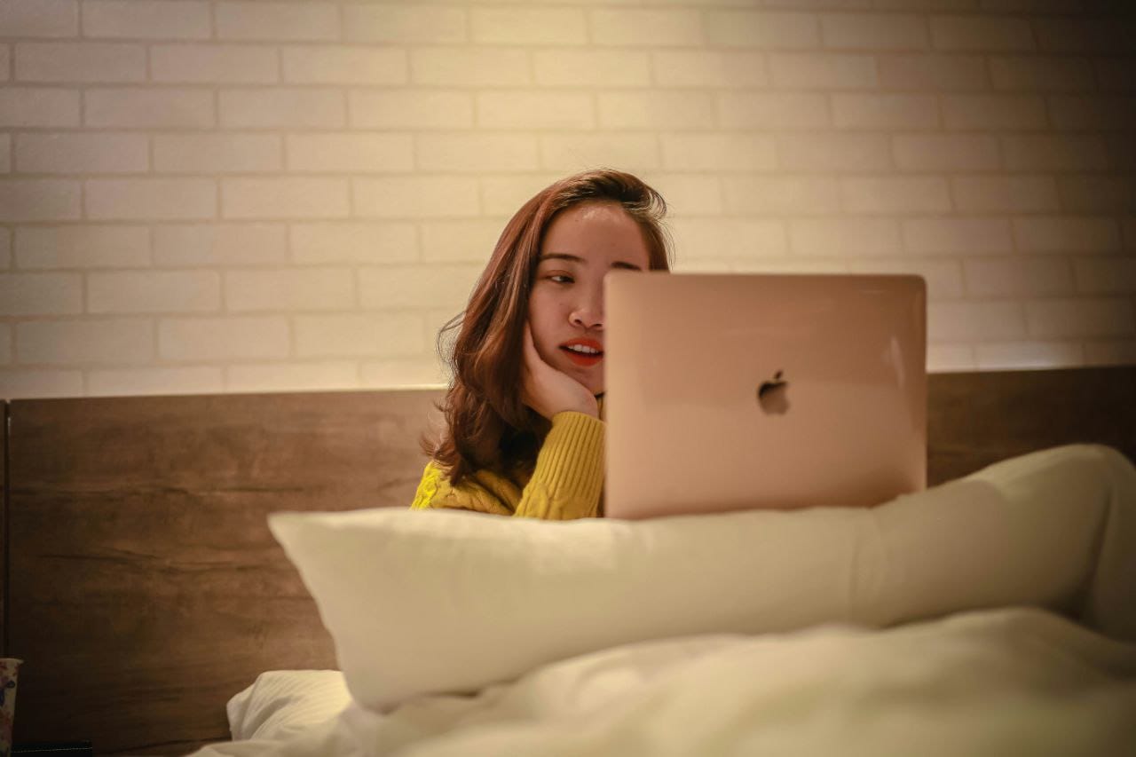 Young woman working on laptop from home